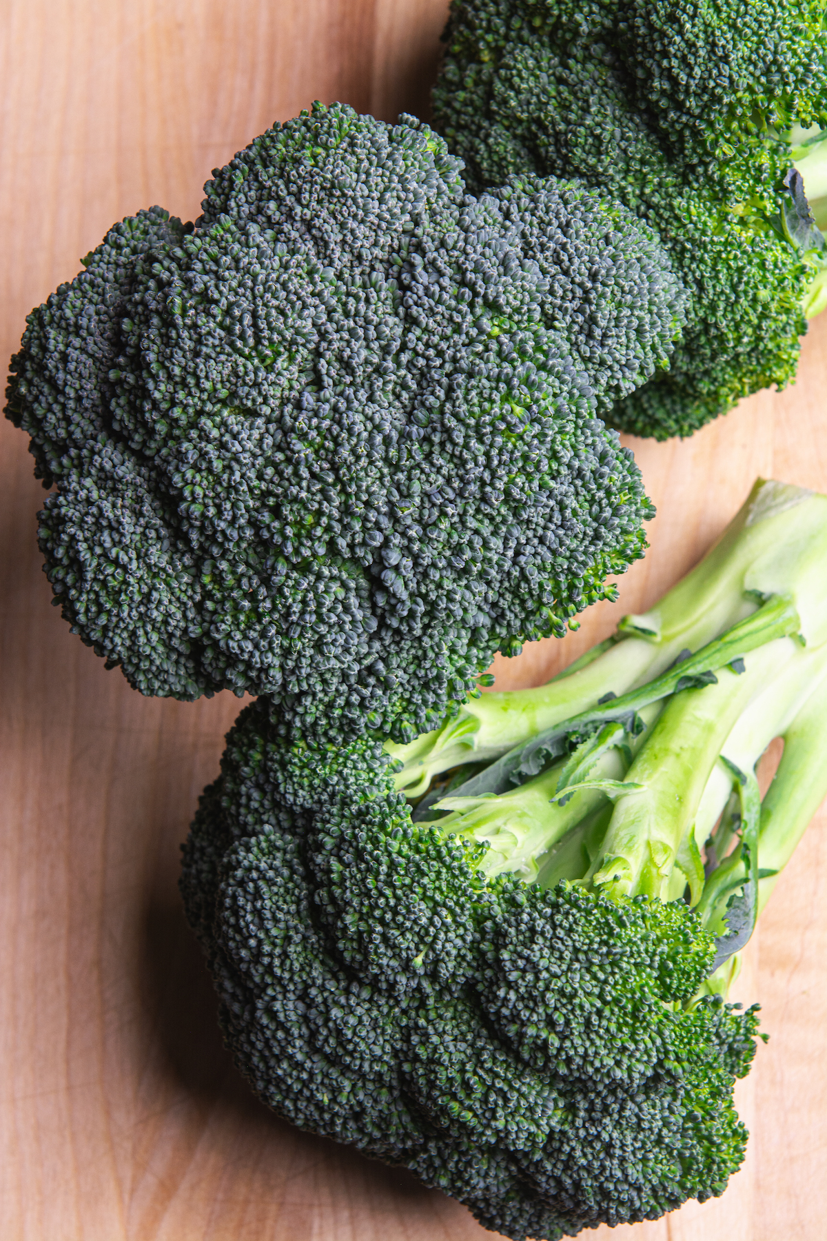 Three heads of raw broccoli