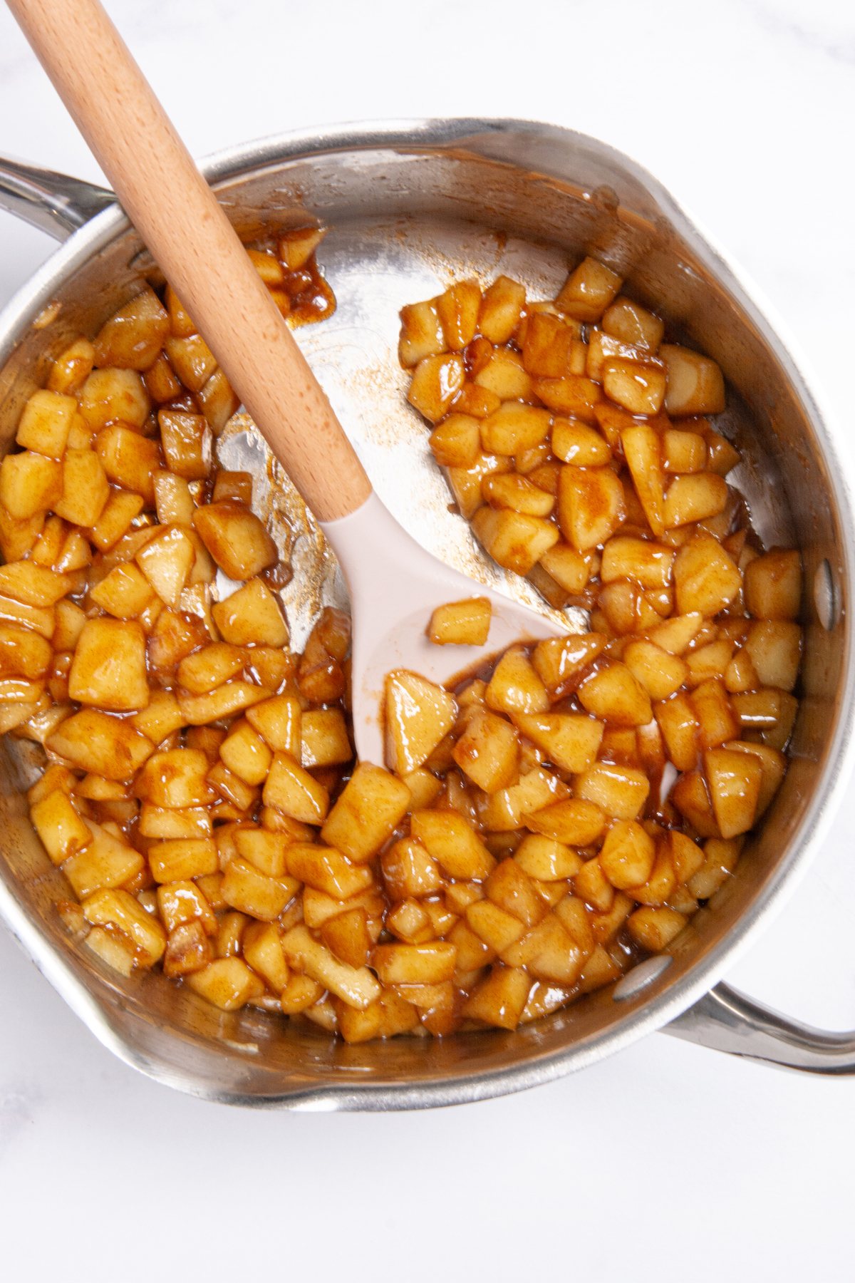 A pot with caramelized diced apples to use as filling for apple turnovers.