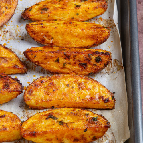 A baking sheet with oven baked potato wedges