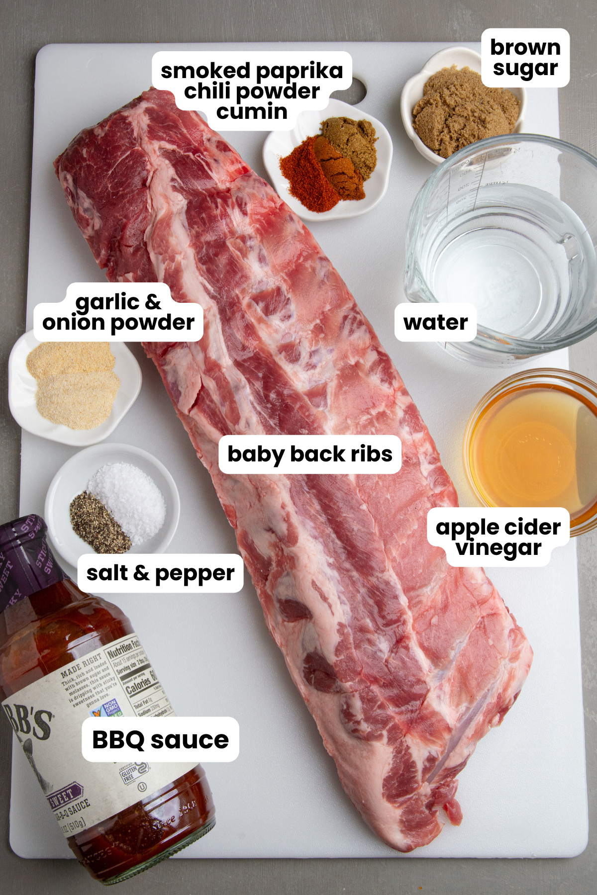 Ingredients for making Instant Pot Ribs, baby back ribs, smoked paprika, chili powder, cumin, brown sugar, onion powder, garlic powder, salt, pepper, water, apple cider vinegar, and BBQ sauce.