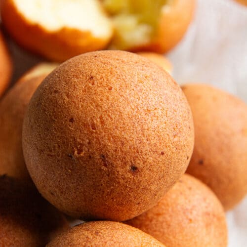 A stack of golden brown Colombian buñuelos.