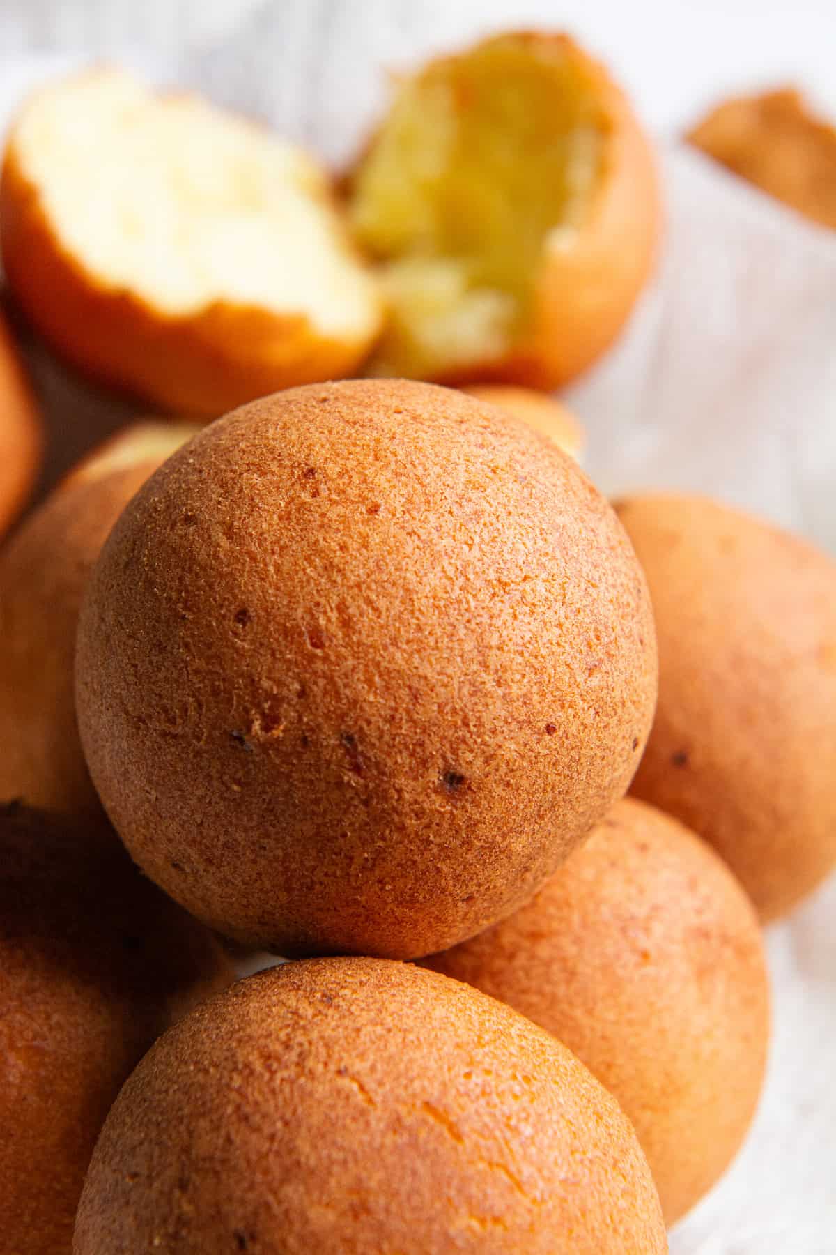 A stack of golden brown Colombian buñuelos.