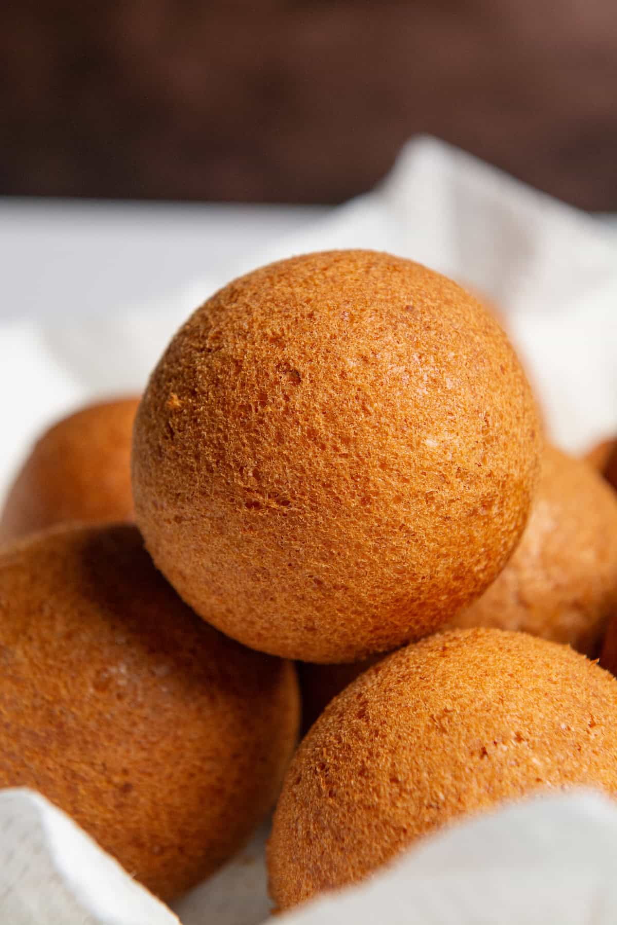 A stack of golden brown Colombian buñuelos.