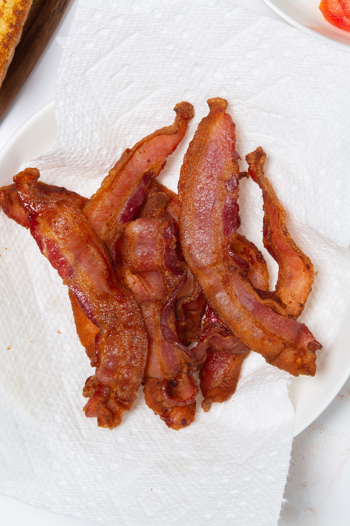 A plate with crispy air fryer bacon.
