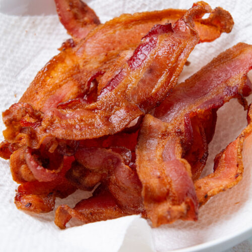 A plate with crispy air fryer bacon.
