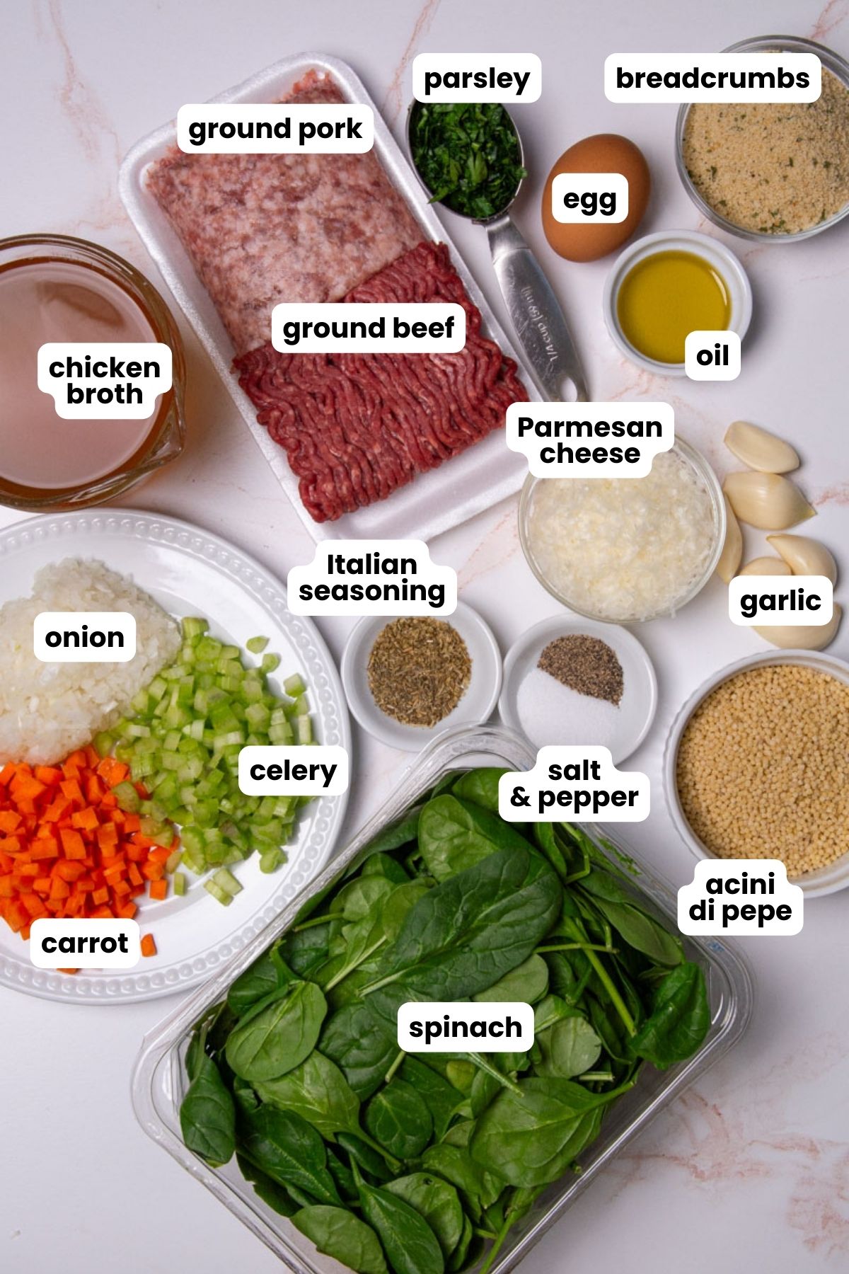 List of ingredientes for an Italian Wedding Soup which include ground pork, ground beef, parsley, breadcrumbs, one egg, oil, Parmesan cheese, six garlic cloves, Italian seasoning, chicken broth, onion, carrot, celery, spinach, acini di pepe pasta, salt, and black pepper.