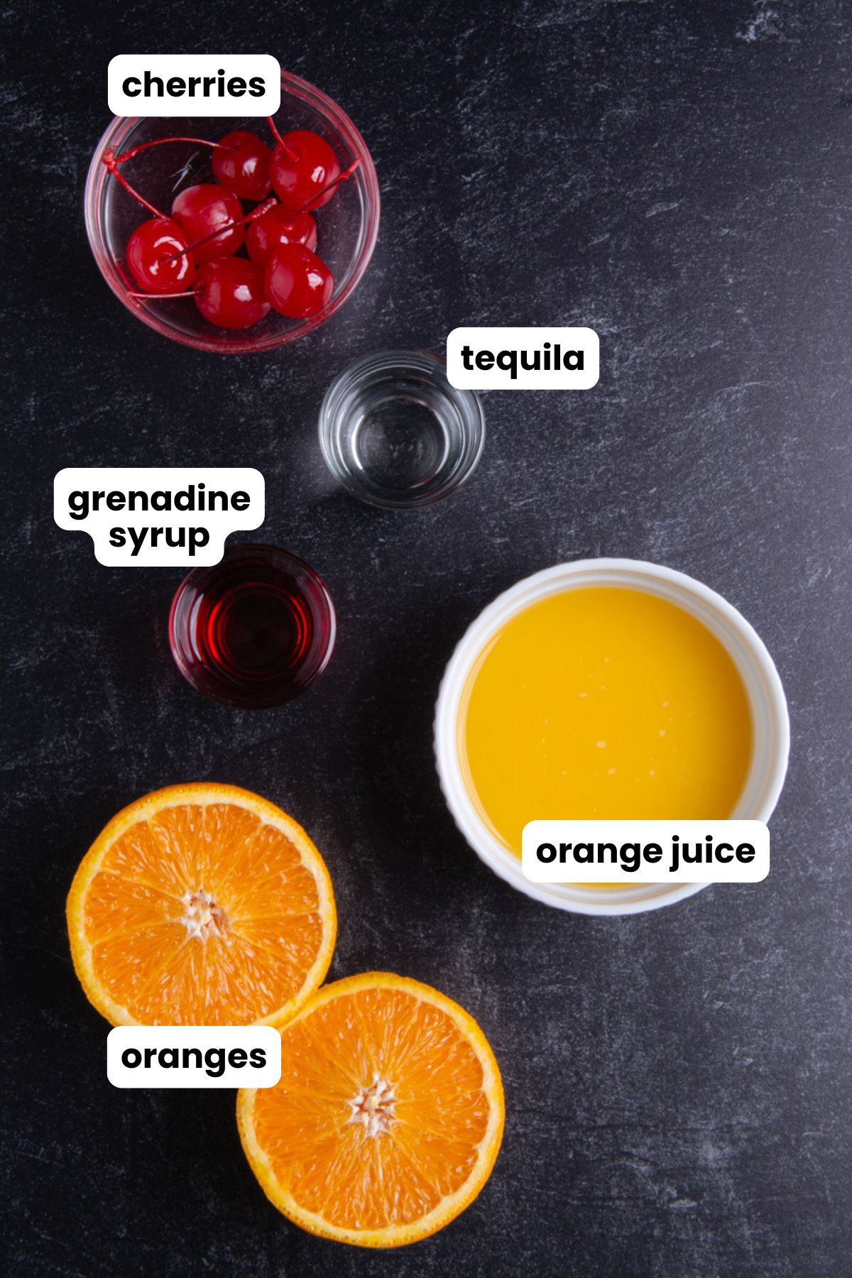 Overhead flat lay of tequila sunrise ingredients on a dark surface: maraschino cherries, a shot of tequila, grenadine syrup, fresh orange juice, and halved oranges, each labeled with text overlays.